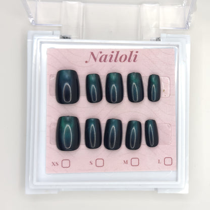 Emerald cat eye set on its backing card inside the open clear Nailoli case