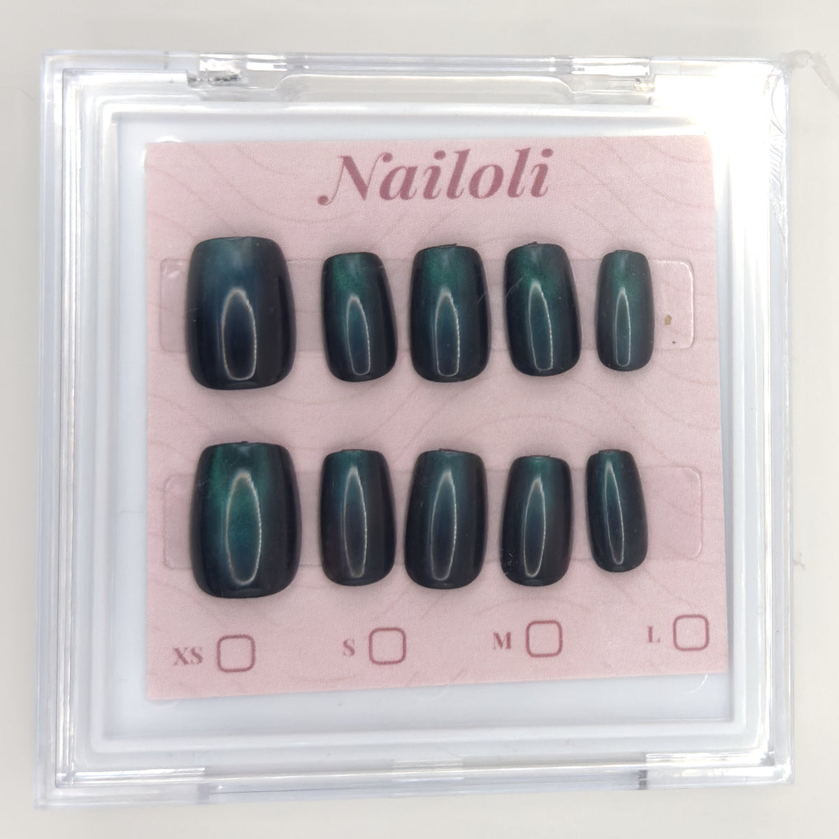 Emerald cat eye set inside the closed clear Nailoli case