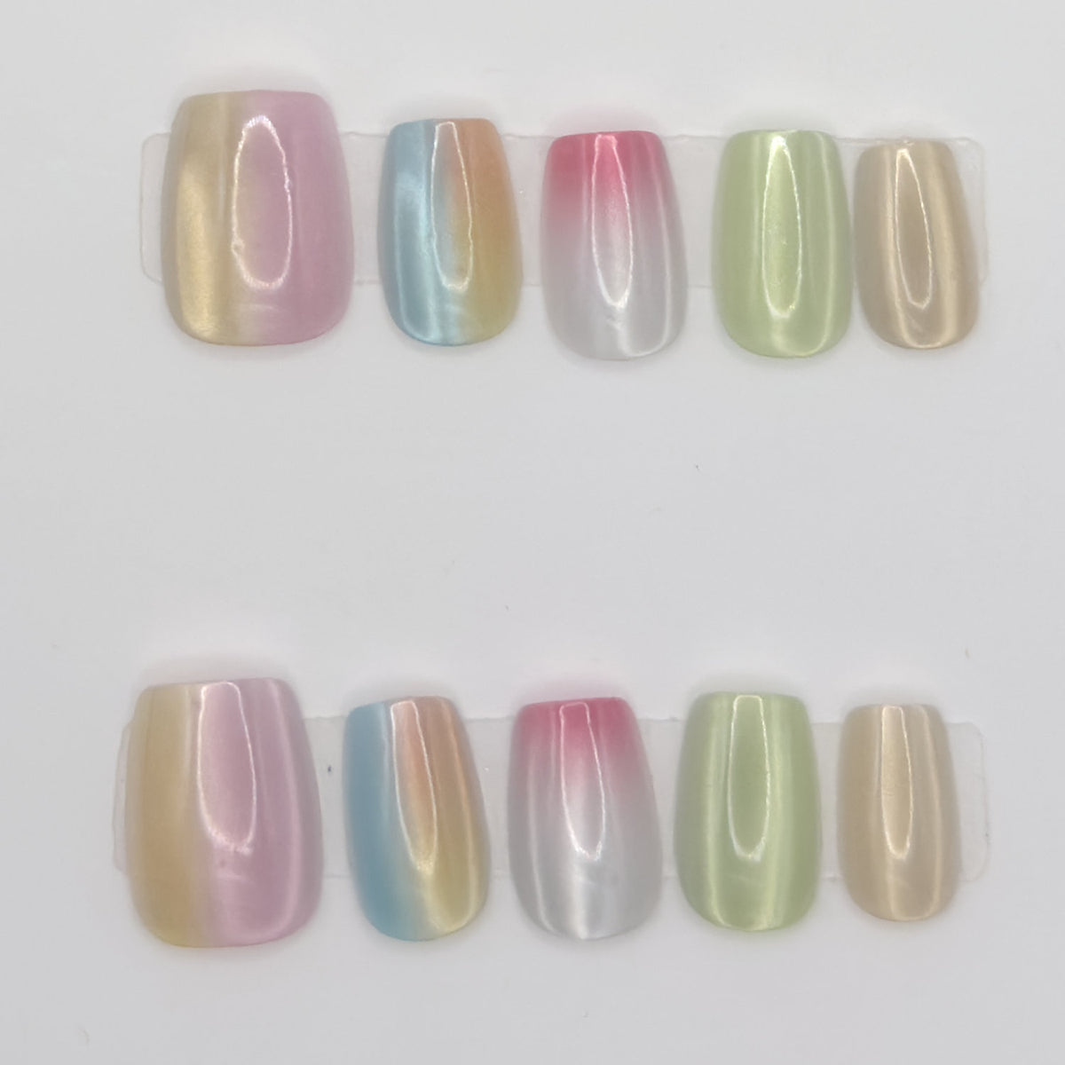 10 pastel chrome square press-ons in two rows, each nail a different ombre chrome shade