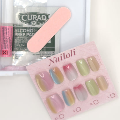Pastel chrome set on its card beside the open kit with nail glue, prep pad, and nail file