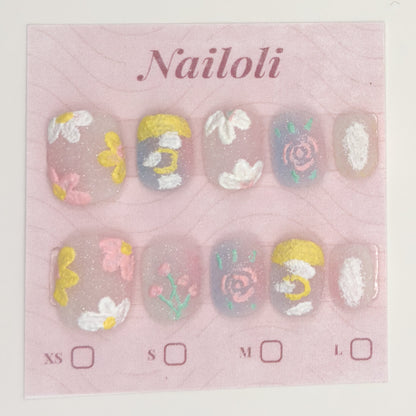 Milky pastel nails on the pink Nailoli backing card with XS, S, M, and L size boxes