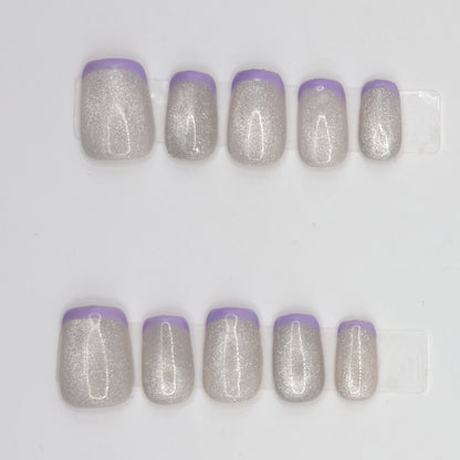 Close-up of 10 silver holographic square press-ons in two rows with thin lavender French tips