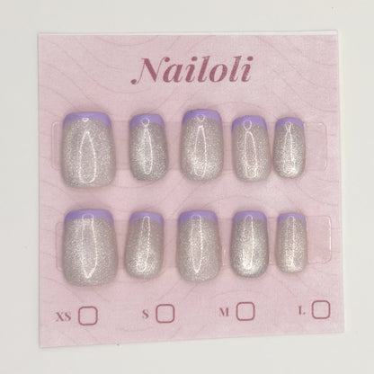 Silver holographic nails on the pink Nailoli backing card with XS, S, M, and L size boxes
