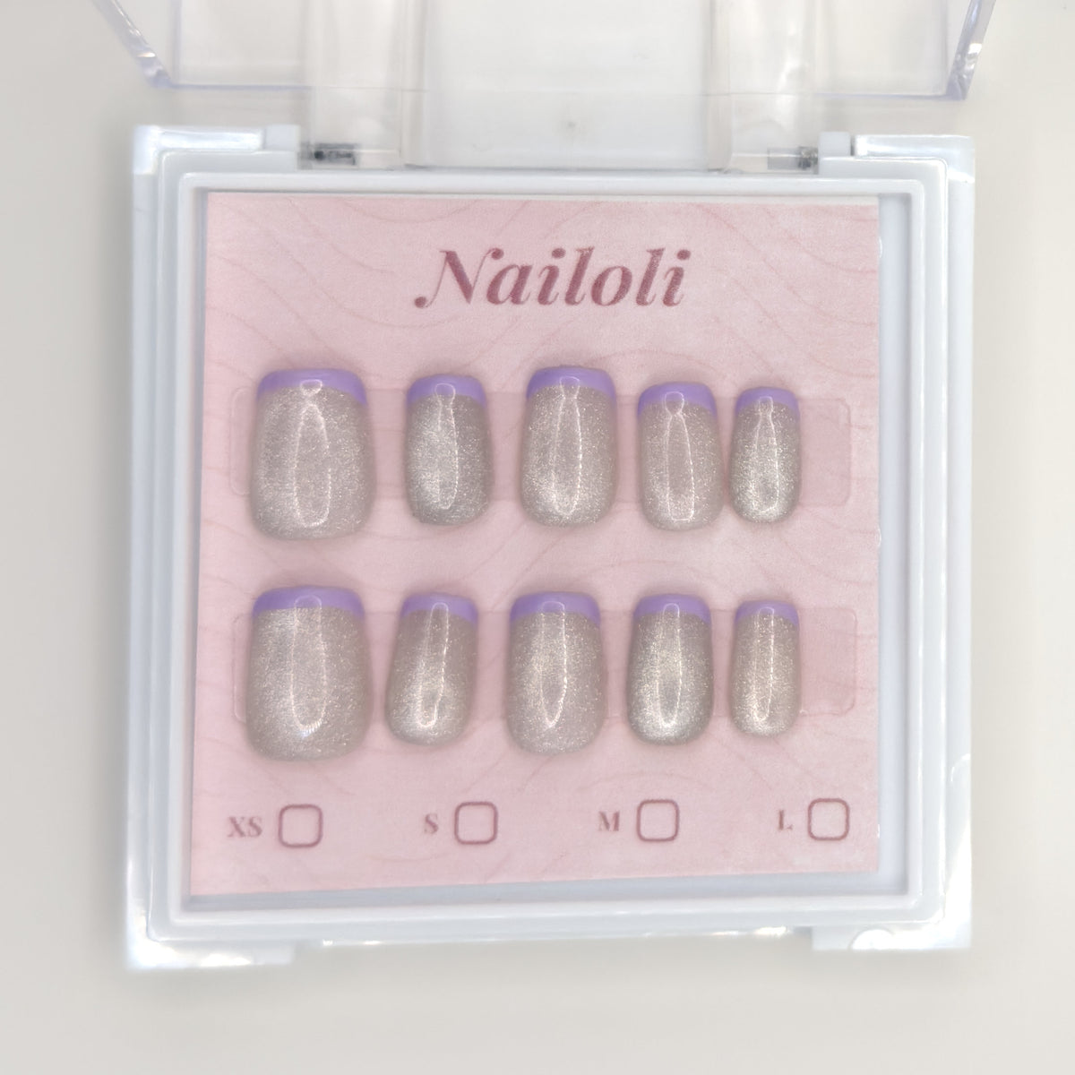Silver holographic set on its backing card inside the open clear Nailoli case