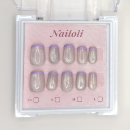 Silver holographic set on its backing card inside the open clear Nailoli case