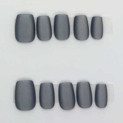 10 matte charcoal gray square press-ons in two rows on a light background