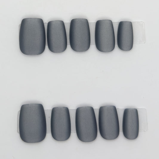 10 matte charcoal gray square press-ons in two rows on a light background