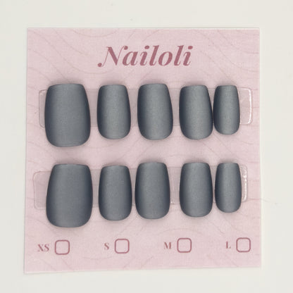 Matte charcoal nails on the pink Nailoli backing card with XS, S, M, and L size boxes