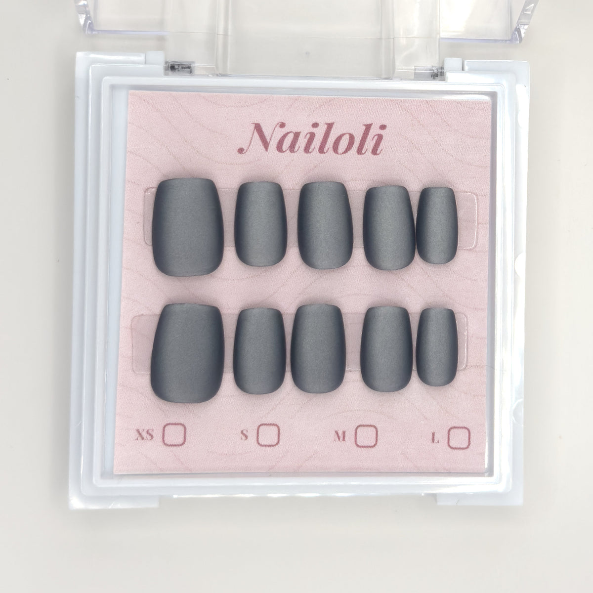 Matte charcoal set on its backing card inside the open clear Nailoli case