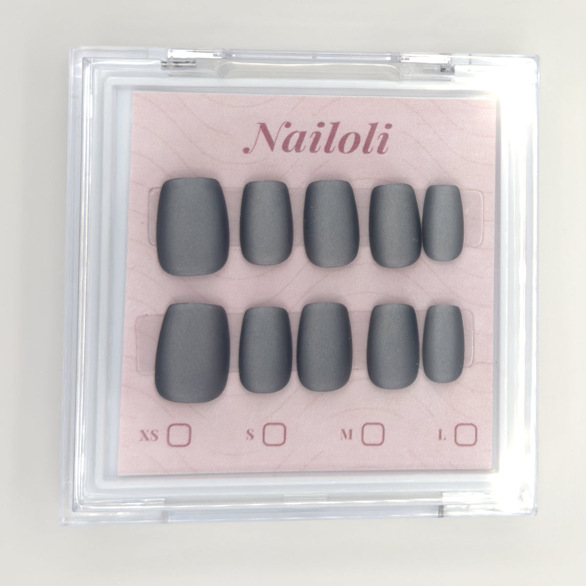 Matte charcoal set inside the closed clear Nailoli case