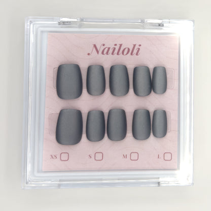 Matte charcoal set inside the closed clear Nailoli case