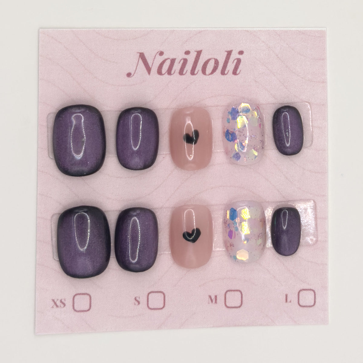 Velvet plum nails on the pink Nailoli backing card with XS, S, M, and L size boxes