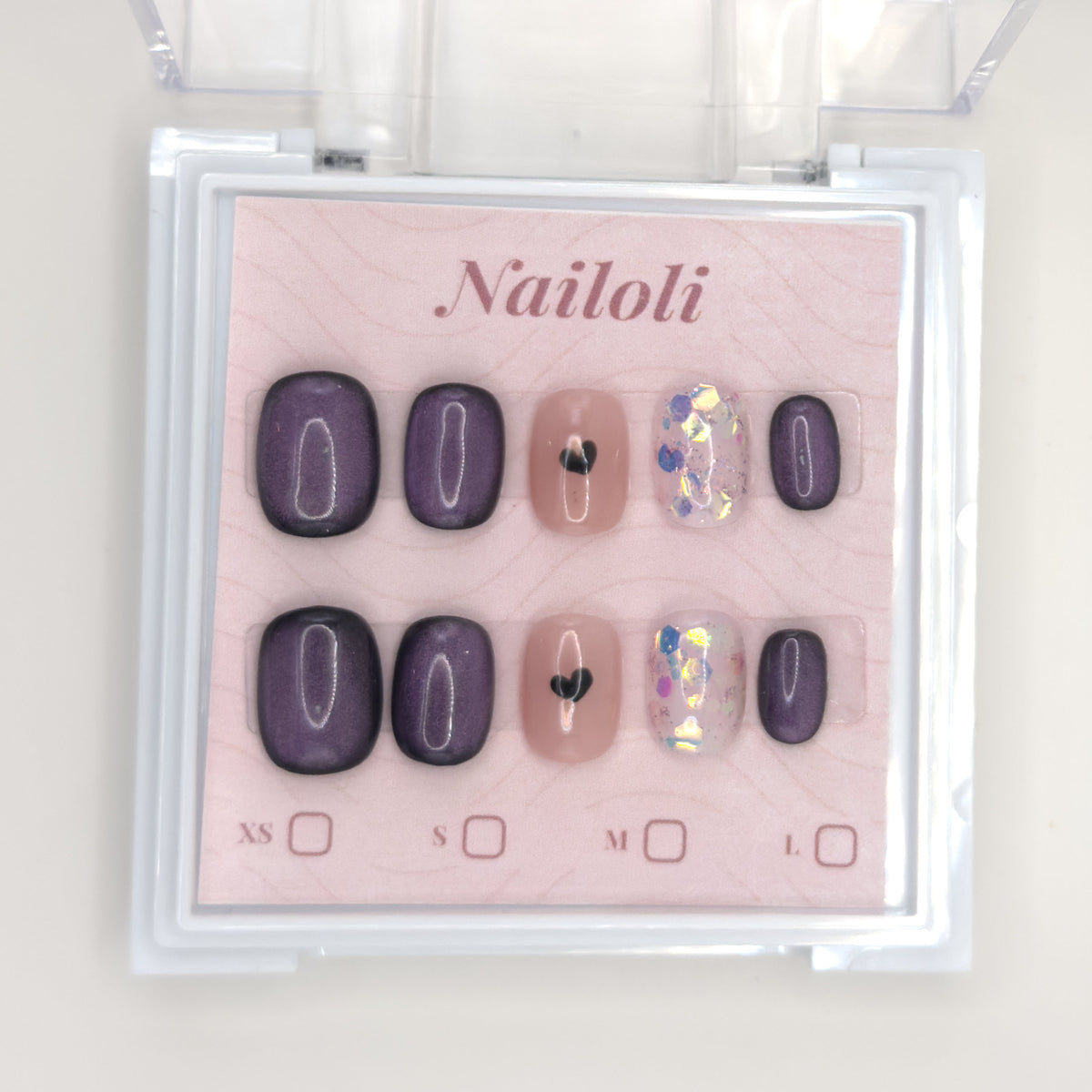 Velvet plum set on its backing card inside the open clear Nailoli case