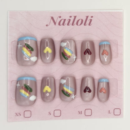 Taupe heart nails on the pink Nailoli backing card with XS, S, M, and L size boxes