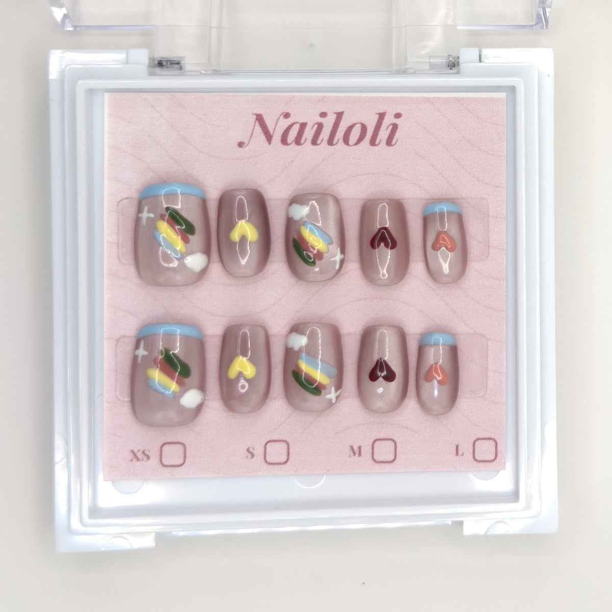 Taupe heart set inside the closed clear Nailoli case