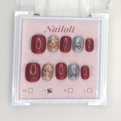 Burgundy glitter set on the Nailoli backing card with size S marked, inside the open clear case
