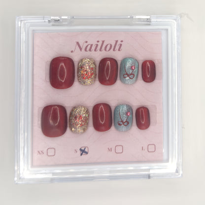 Burgundy glitter set on its backing card inside the closed clear Nailoli case