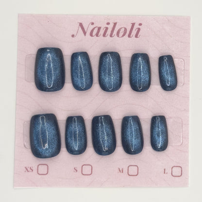 Midnight cat eye nails on the pink Nailoli backing card with XS, S, M, and L size boxes