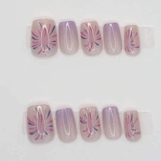 10 press-ons in two rows, alternating pink starburst line art and solid lavender ombre nails