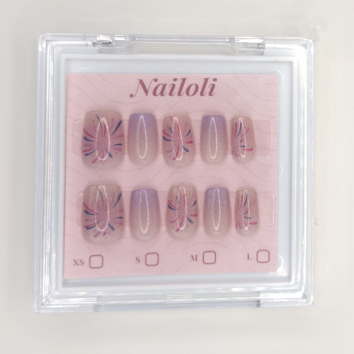 Lavender starburst set on its backing card inside the closed clear Nailoli case