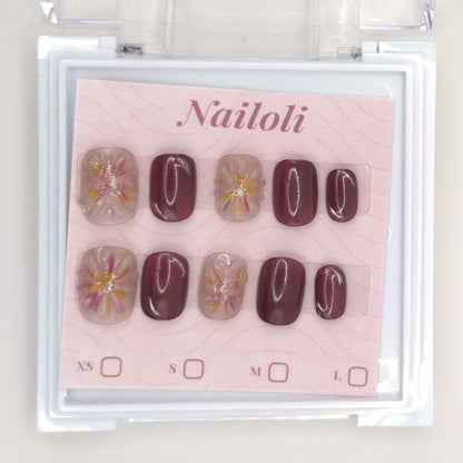 Mauve blossom set on its backing card inside the open clear Nailoli case