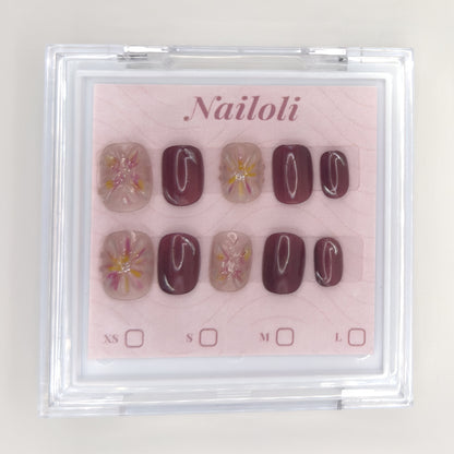 Mauve blossom set inside the closed clear Nailoli case