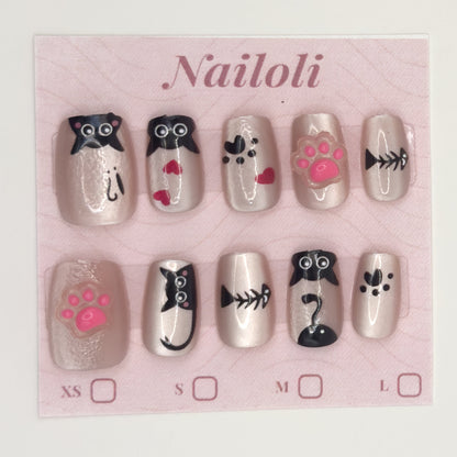 Kawaii cat nails on the pink Nailoli backing card with XS, S, M, and L size boxes