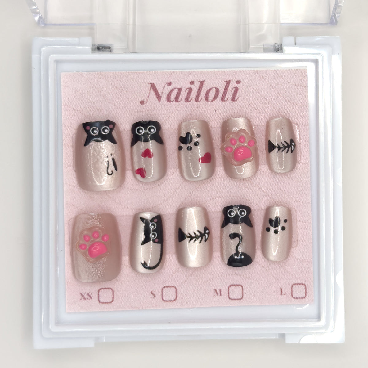 Kawaii cat set on its backing card inside the open clear Nailoli case