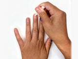 Applying a thin layer of nail glue to a bare natural nail