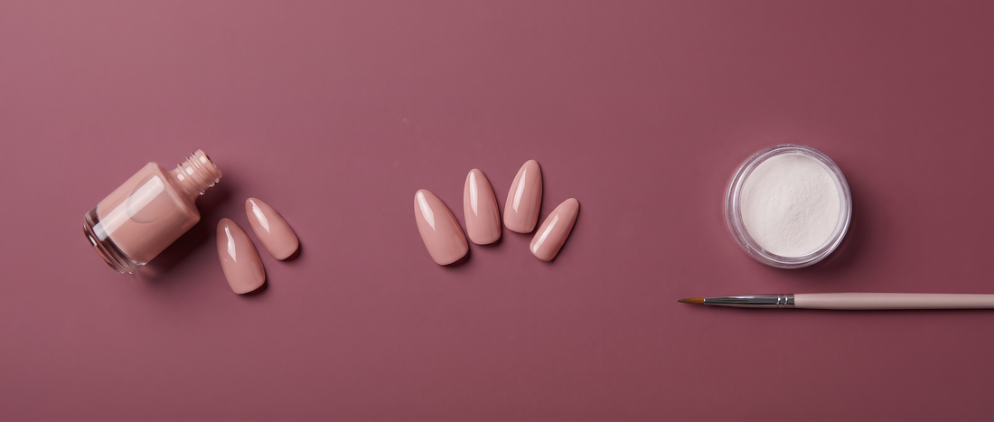 Gel polish bottle, nude press-on nails, and acrylic powder with a brush on a mauve background