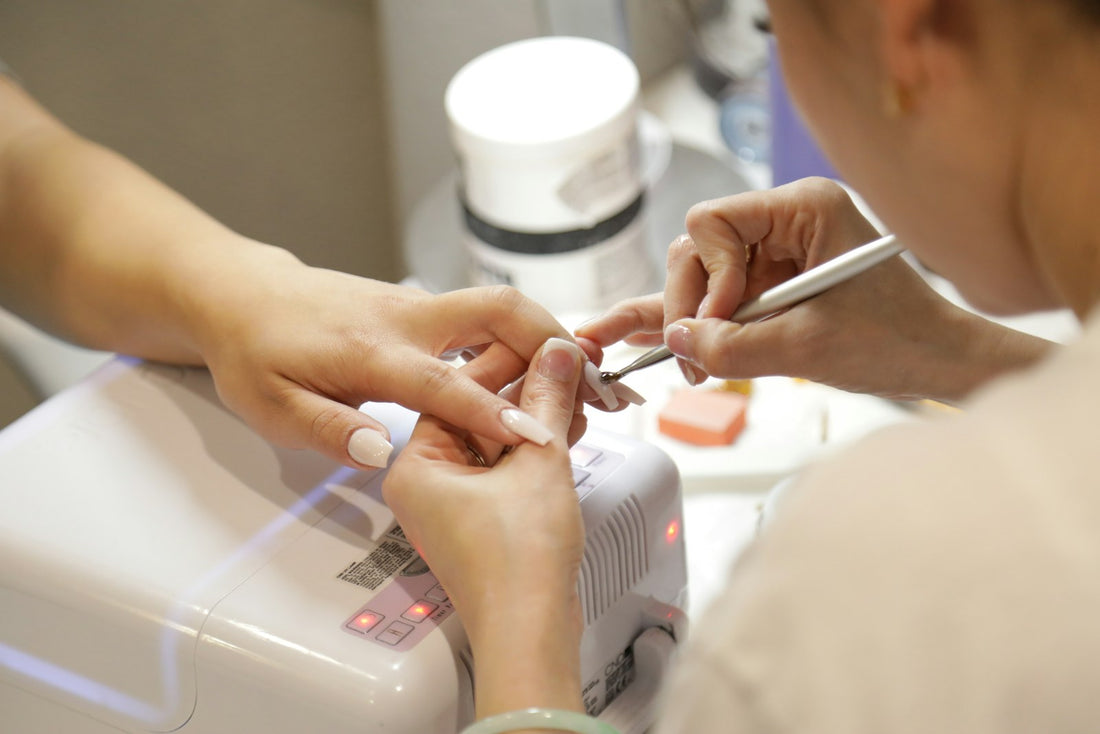 Close-up of a manicure application in progress